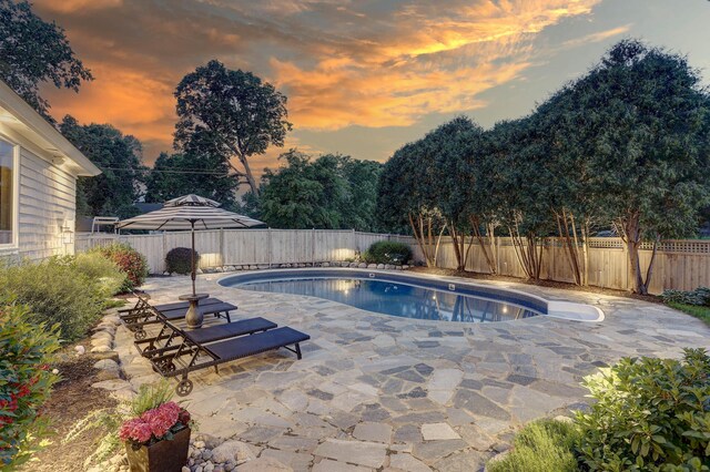 2625 Woodbridge Rd, Minnetonka Beach, MN 55391 - pool at dusk featuring a patio area and a fenced backyard