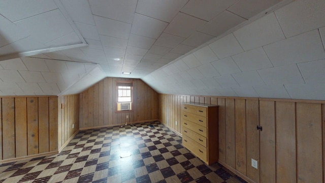additional living space featuring tile patterned floors, cooling unit, baseboards, lofted ceiling, and wooden walls
