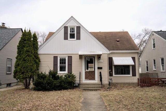 view of front of house with fence, entry steps, and board and batten siding
