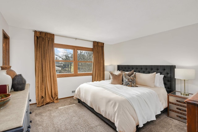 bedroom featuring baseboards and light carpet