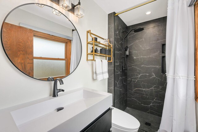 bathroom with vanity, recessed lighting, a marble finish shower, and toilet