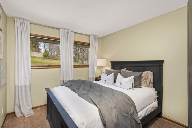 carpeted bedroom featuring baseboards