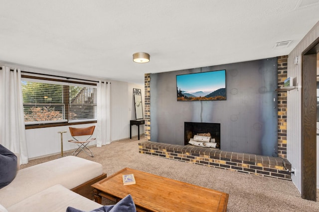 living room featuring carpet floors, baseboards, a brick fireplace, and visible vents