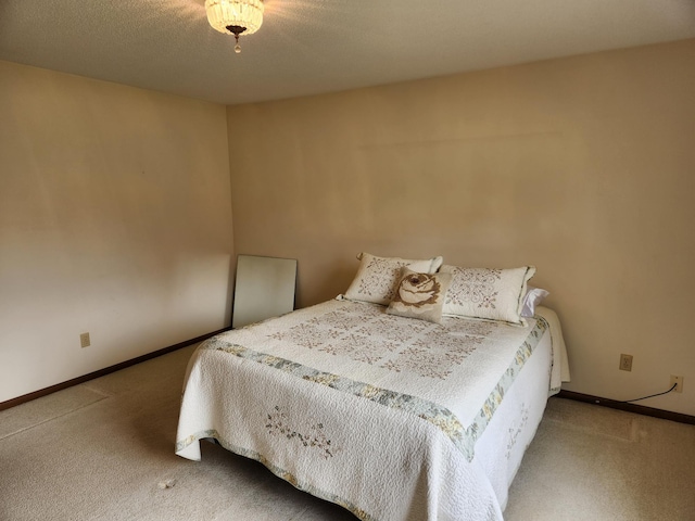 bedroom featuring carpet floors and baseboards