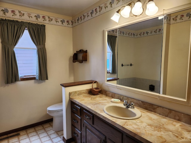 bathroom with vanity, visible vents, baseboards, and toilet