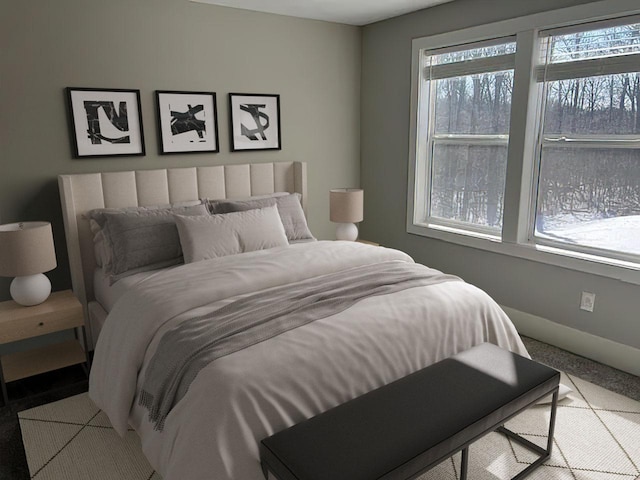 bedroom with baseboards and carpet