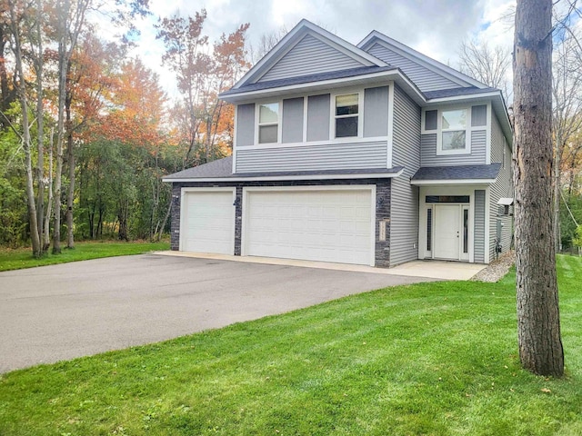 13357 Two Mile Rd, Brainerd, MN 56401 - view of front of house featuring asphalt driveway, a front yard, a shingled roof, an attached garage, and stone siding
