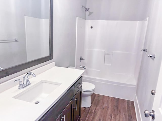 13357 Two Mile Rd, Brainerd, MN 56401 - bathroom with toilet, wood finished floors, vanity, and washtub / shower combination