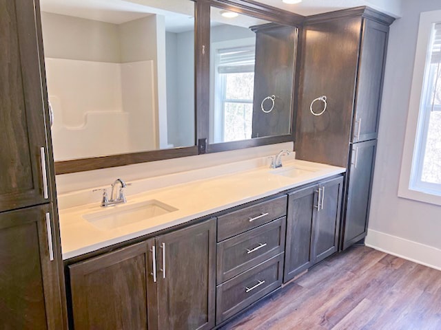 13357 Two Mile Rd, Brainerd, MN 56401 - bathroom with healthy amount of natural light, wood finished floors, baseboards, and double vanity