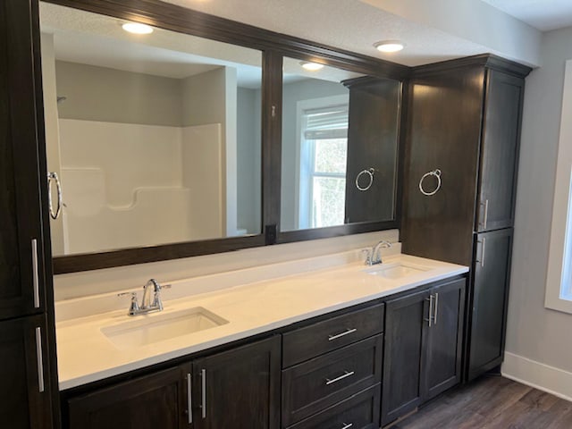 13357 Two Mile Rd, Brainerd, MN 56401 - bathroom with wood finished floors, baseboards, and double vanity