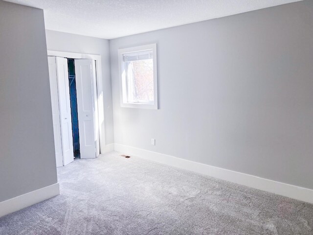 13357 Two Mile Rd, Brainerd, MN 56401 - unfurnished bedroom featuring carpet flooring, baseboards, a closet, and a textured ceiling