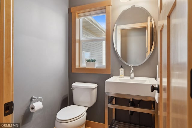 bathroom featuring vanity, baseboards, and toilet