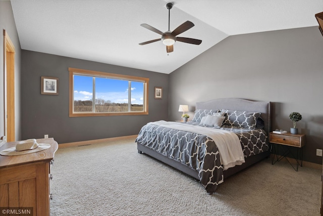 carpeted bedroom with baseboards, vaulted ceiling, and ceiling fan