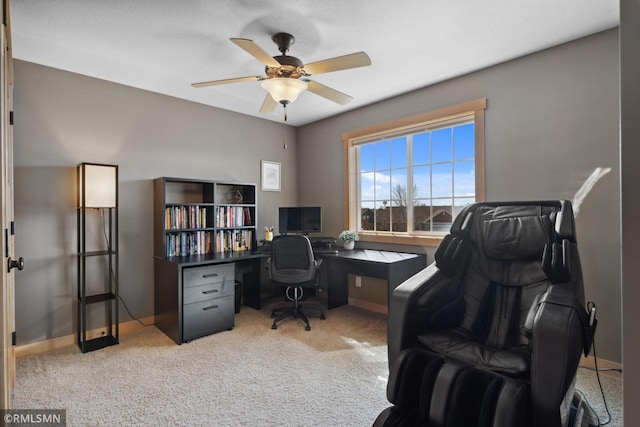 home office featuring ceiling fan, light colored carpet, and baseboards