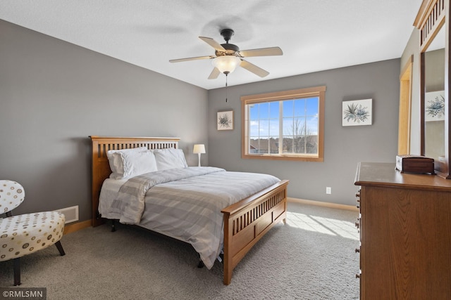 bedroom featuring ceiling fan, light colored carpet, and baseboards