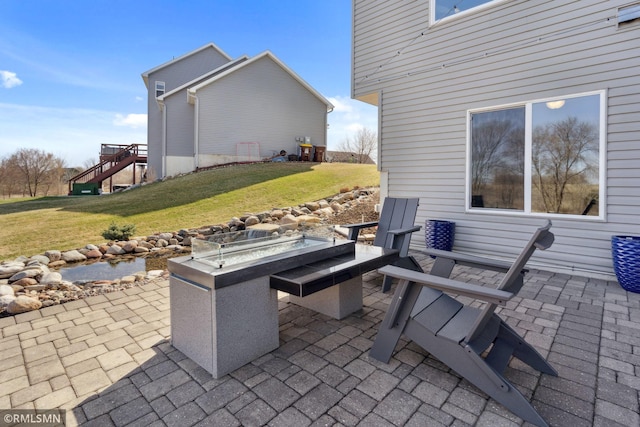 view of patio featuring a fire pit and stairs