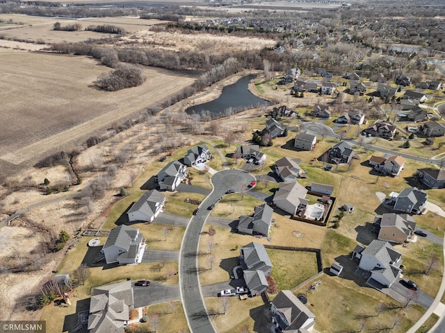 birds eye view of property with a water view and a residential view
