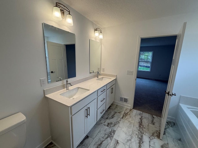 full bath with baseboards, toilet, marble finish floors, double vanity, and a textured ceiling