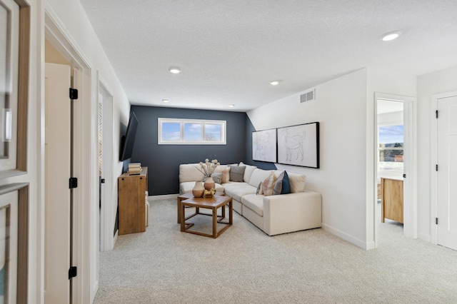 living area with carpet flooring, baseboards, recessed lighting, and a textured ceiling