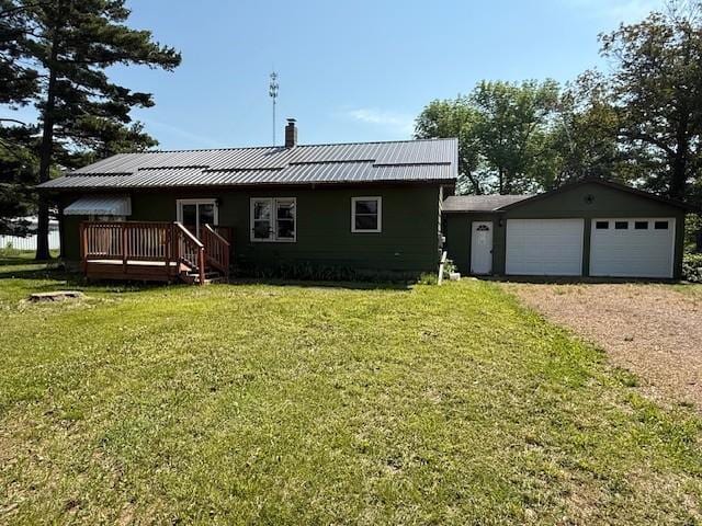 39698 10th Ave, Isle, MN 56342 - rear view of house featuring a chimney, a lawn, a metal roof, a wooden deck, and a garage