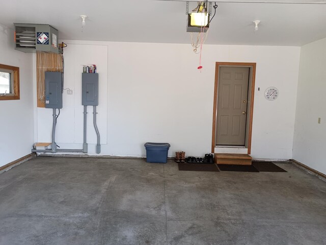 garage with electric panel, baseboards, and a garage door opener
