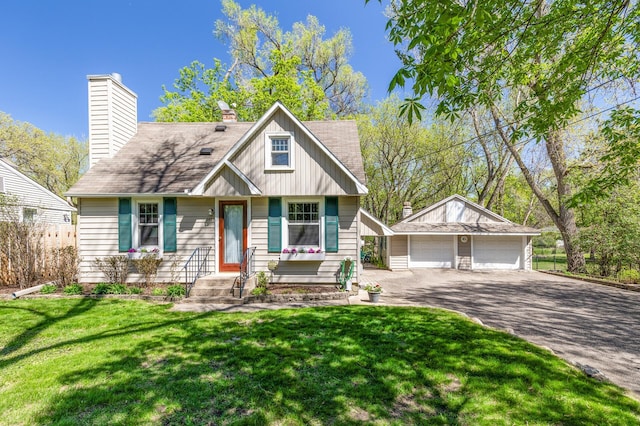 3021 Atwater St, Hopkins, MN 55305 - view of front facade featuring an outbuilding, a garage, and a chimney