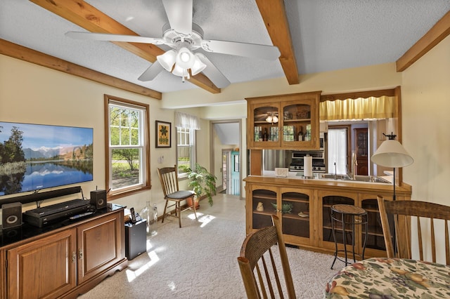 3021 Atwater St, Hopkins, MN 55305 - dining area featuring beamed ceiling, a textured ceiling, ceiling fan, and light carpet