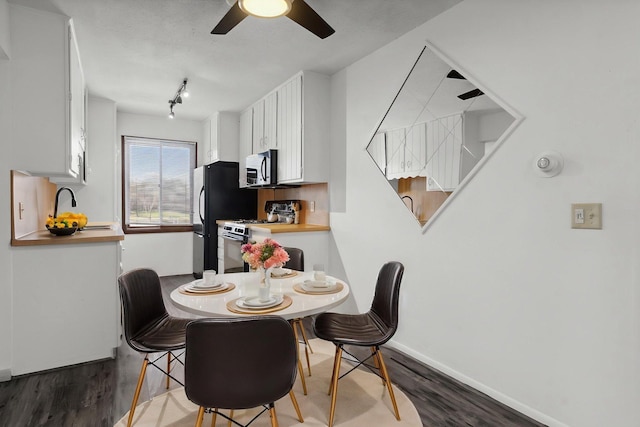 10720 Rockford Rd Unit 215, Plymouth, MN 55442 - dining space featuring wood finished floors, ceiling fan, and track lighting