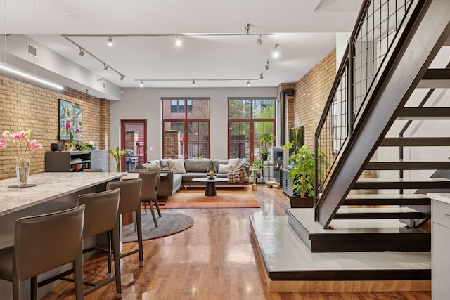 common area featuring brick wall and stairway