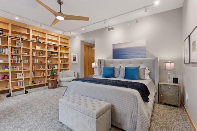 carpeted bedroom featuring rail lighting and ceiling fan