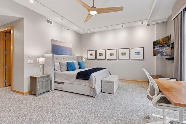 bedroom featuring track lighting, carpet, baseboards, and a ceiling fan