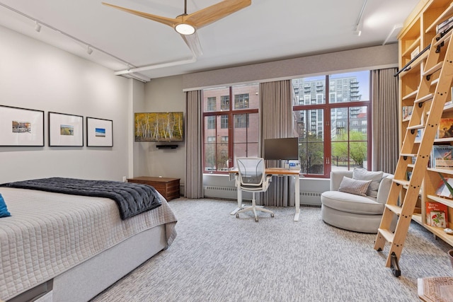 carpeted bedroom with rail lighting, a desk, and ceiling fan
