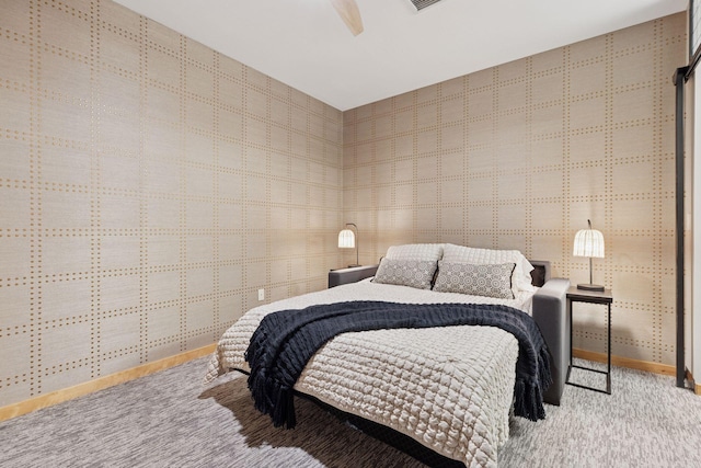 carpeted bedroom featuring baseboards and ceiling fan