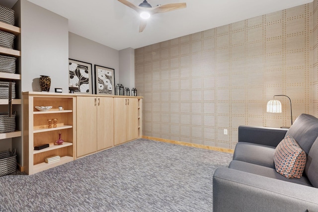 living room with ceiling fan, carpet flooring, baseboards, and wallpapered walls