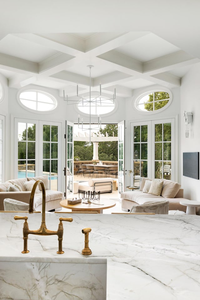 sunroom featuring coffered ceiling, french doors, and beamed ceiling