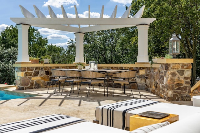 view of patio featuring outdoor dining area and a pergola