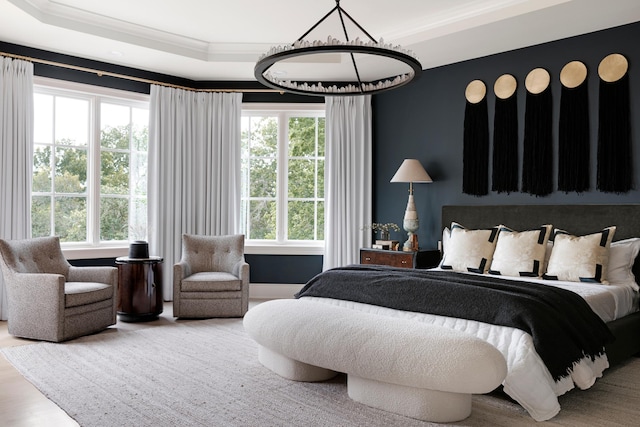 bedroom featuring a tray ceiling, crown molding, and wood finished floors