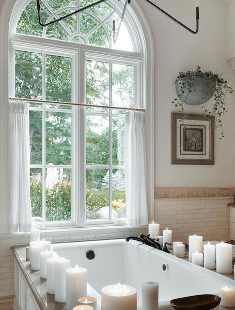 room details with a freestanding bath and wainscoting