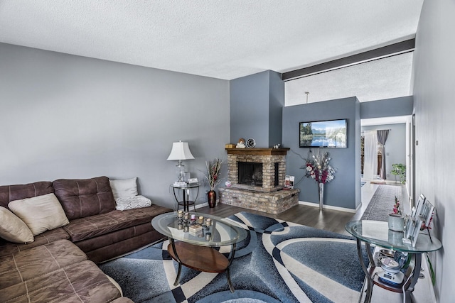 living area featuring baseboards, a textured ceiling, a fireplace, wood finished floors, and lofted ceiling