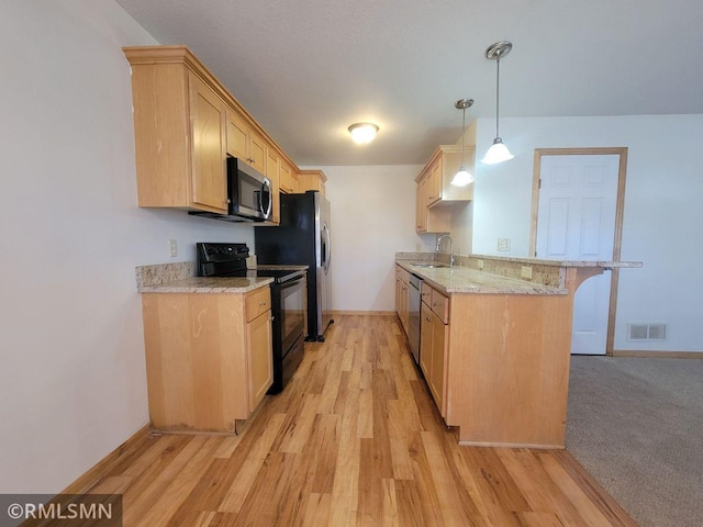 kitchen with light wood-type flooring, baseboards, stainless steel appliances, a sink, and light brown cabinetry