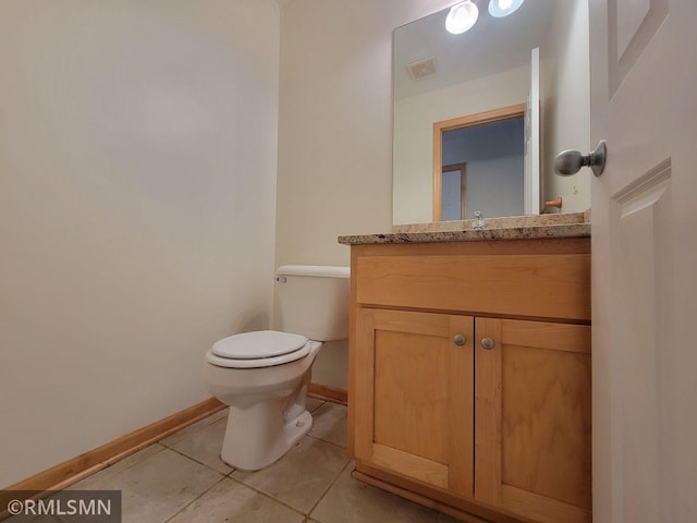 half bathroom featuring vanity, tile patterned flooring, visible vents, toilet, and baseboards