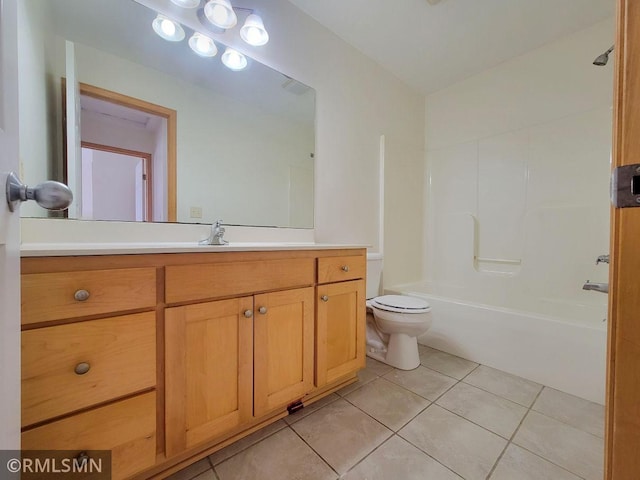 bathroom featuring toilet, bathtub / shower combination, vanity, and tile patterned flooring