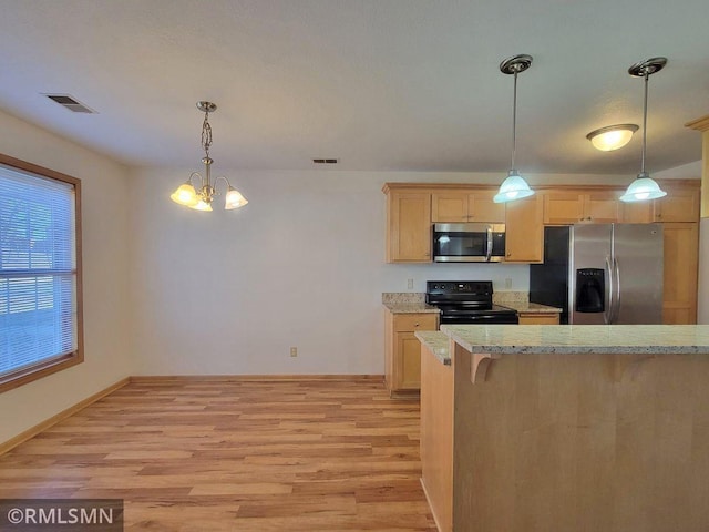 kitchen featuring visible vents, light wood finished floors, an inviting chandelier, and stainless steel appliances