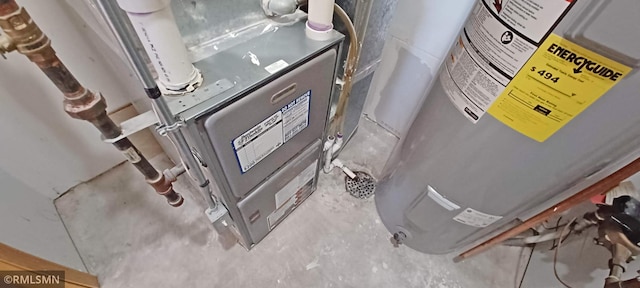 room details with water heater and unfinished concrete flooring