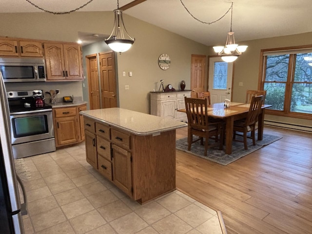 26837 Lake Ethel Rd, Girard Twp, MN 56515 - kitchen with appliances with stainless steel finishes, a baseboard heating unit, vaulted ceiling, light countertops, and hanging light fixtures
