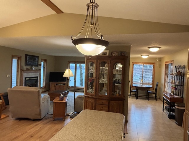 26837 Lake Ethel Rd, Girard Twp, MN 56515 - dining space featuring lofted ceiling and a tiled fireplace