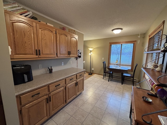 26837 Lake Ethel Rd, Girard Twp, MN 56515 - kitchen featuring a textured ceiling, light countertops, and brown cabinets