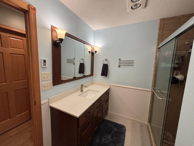 26837 Lake Ethel Rd, Girard Twp, MN 56515 - full bath featuring wainscoting, a textured ceiling, a stall shower, and vanity