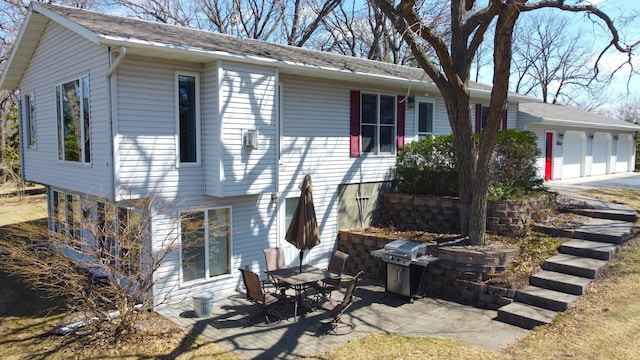 26837 Lake Ethel Rd, Girard Twp, MN 56515 - rear view of property featuring a garage and a patio