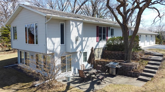 26837 Lake Ethel Rd, Girard Twp, MN 56515 - view of side of home with a patio and a garage
